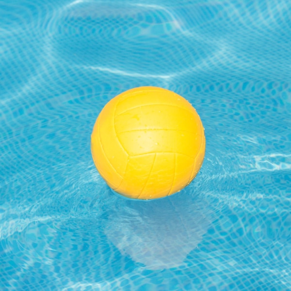 Yellow volleyball on pool